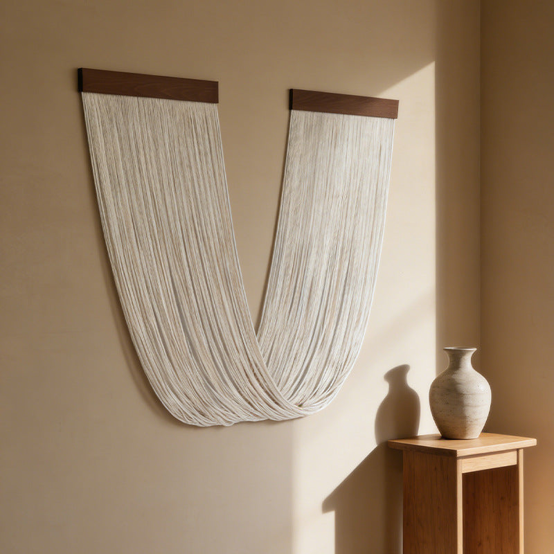 U-Shaped wall hanging detail — tassel fringe and knotted cotton, natural earthy tones