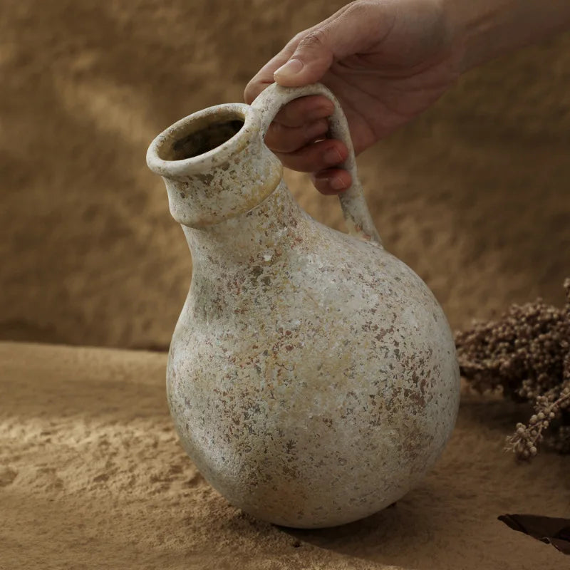 Wabi-sabi stoneware vase styled in earthen setting
