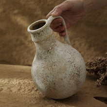 Wabi-sabi stoneware vase styled in earthen setting
