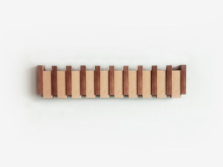 Piano key wall coat rack styled with coats — functional Japandi entryway accessory